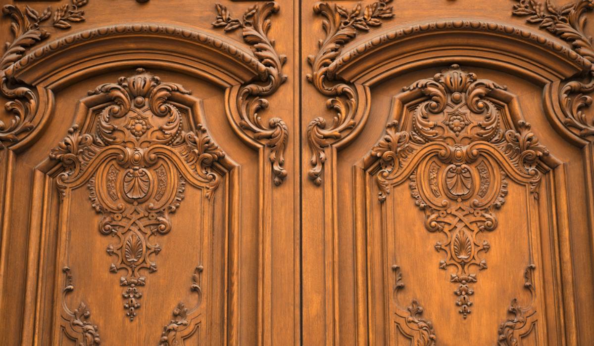 Ornate, custom-carved wooden door in a grand entrance
