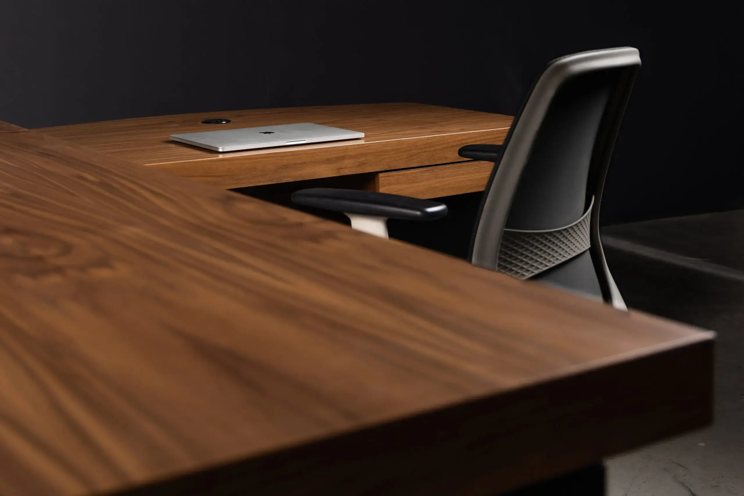 A stylish wooden desk with matching chair