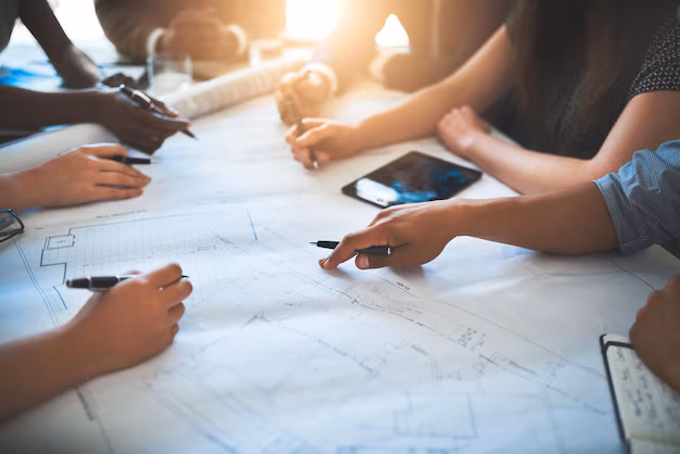 Architect and artisan collaborating over blueprints
